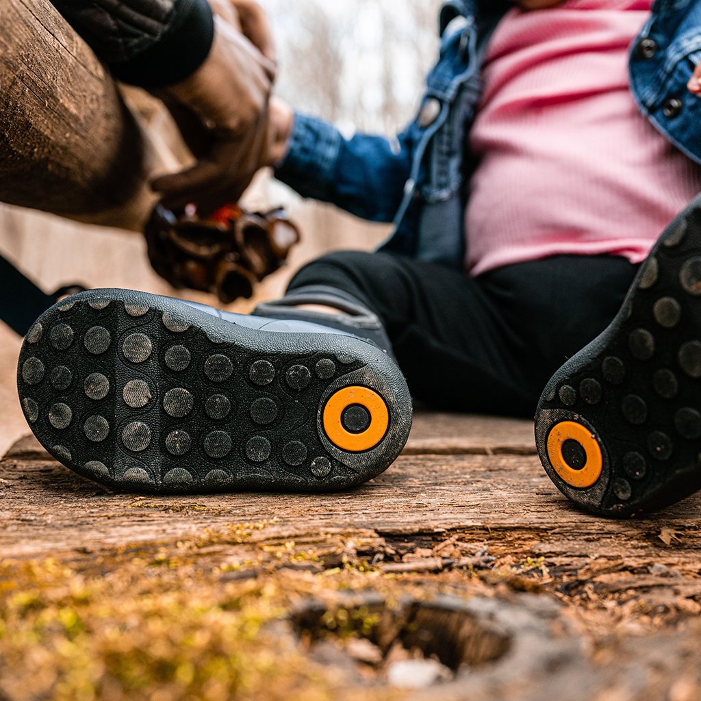 Product image: Bogs Kids Baby Classic Solid Boot Black, lifestyle product shot.