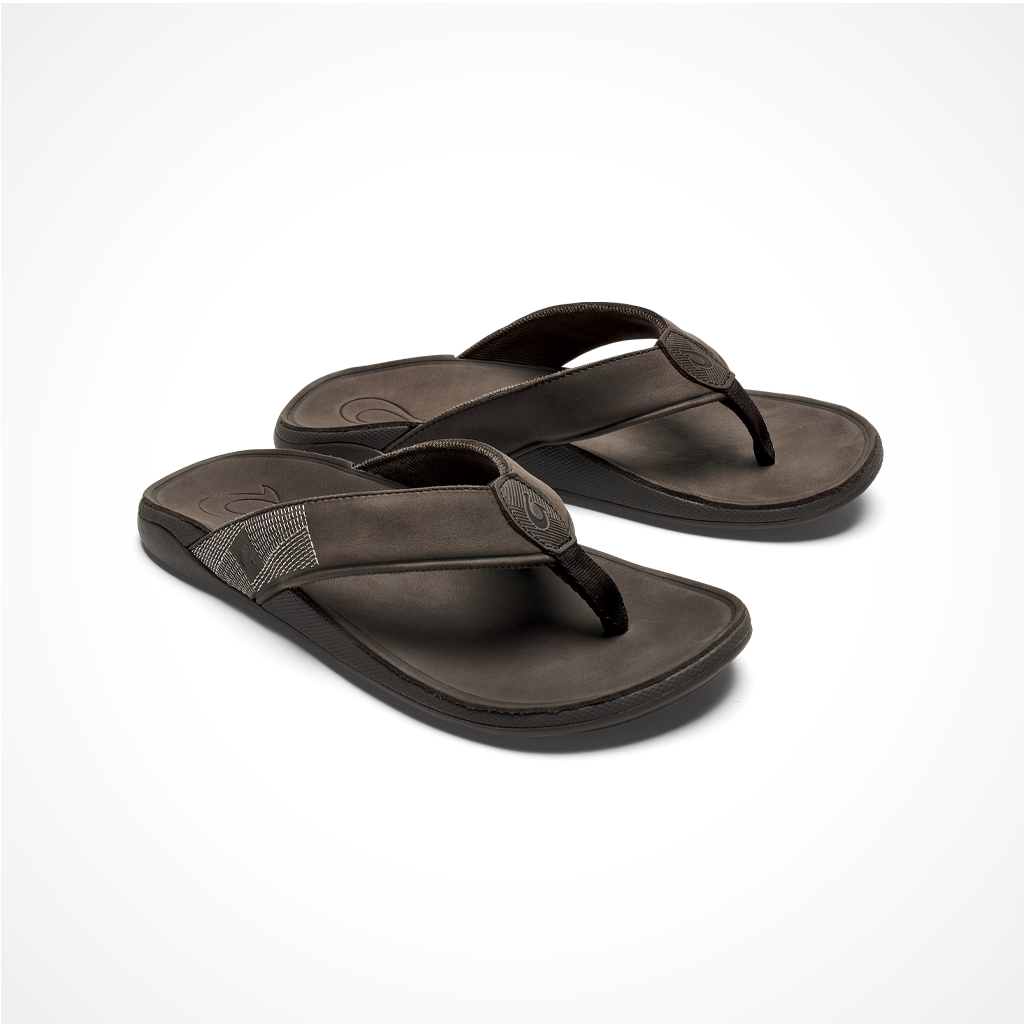 Product image: Footwear Olukai Mens Tuahine Dark Wood, shown from a three-quarter angled view.